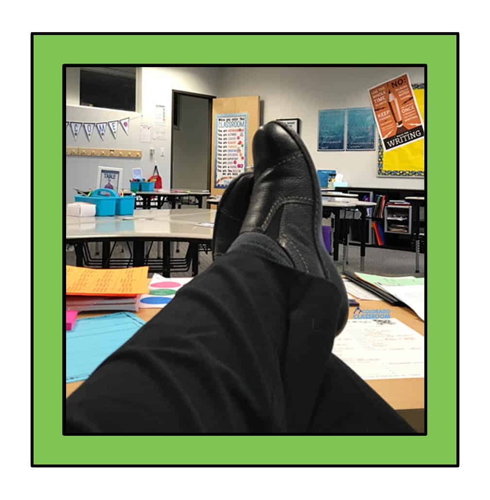 Feet up on a teacher's desk looking out across a classroom.