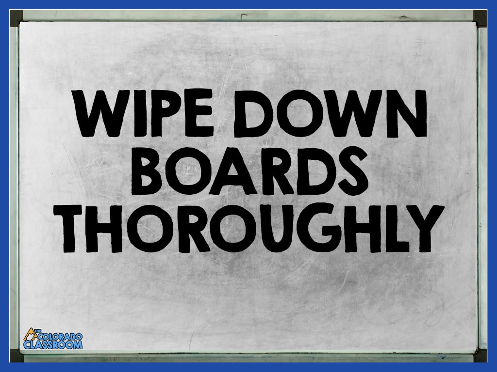 A filthy whiteboard with the text overlay that reads, "Wipe Down Boards Thoroughly."