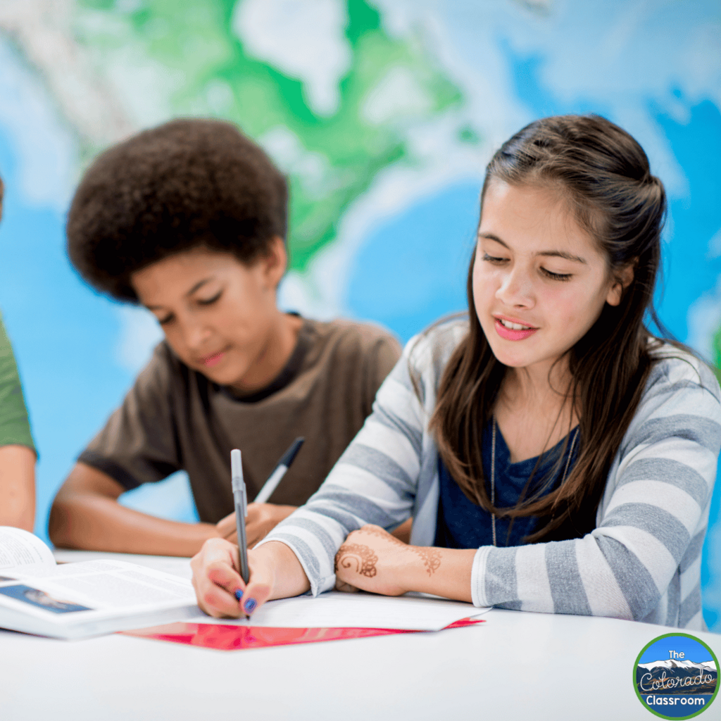 This image shows middle school students sitting at their desks and writing.