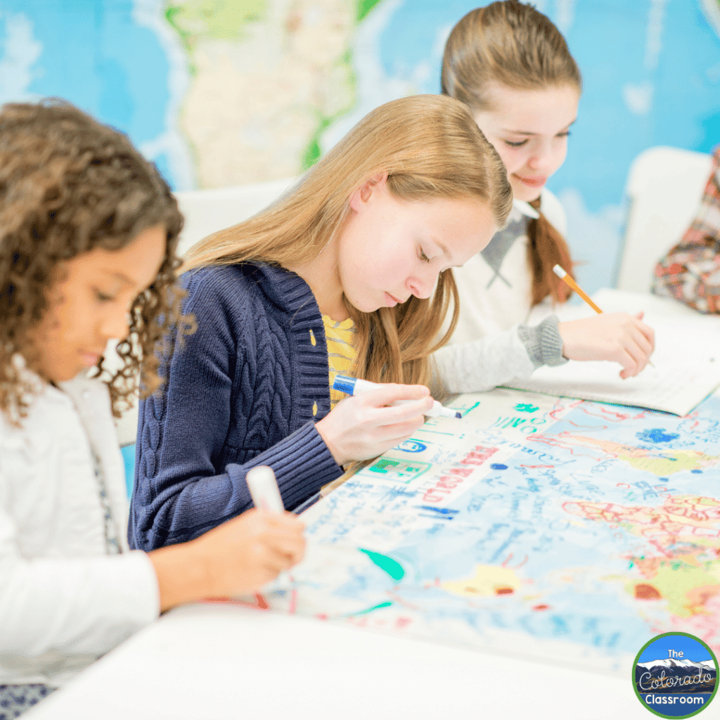 This image shows students looking at a world map.